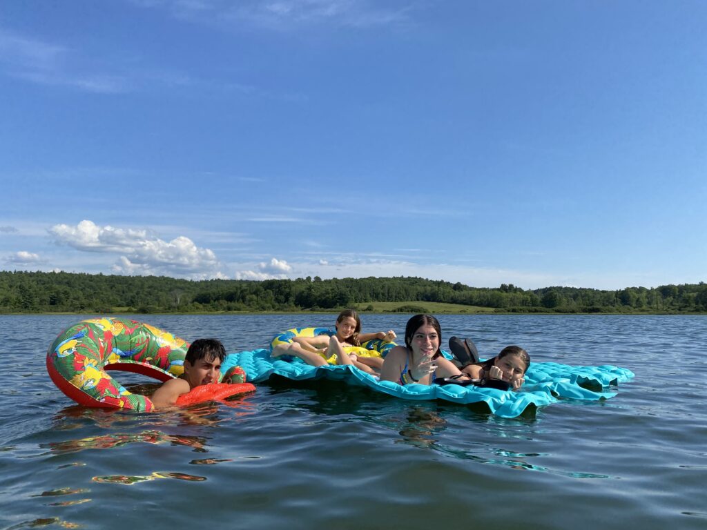 students on rafts in lake