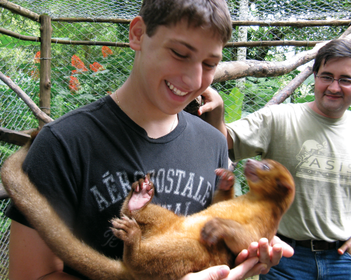 boy holding monkey in costa rica