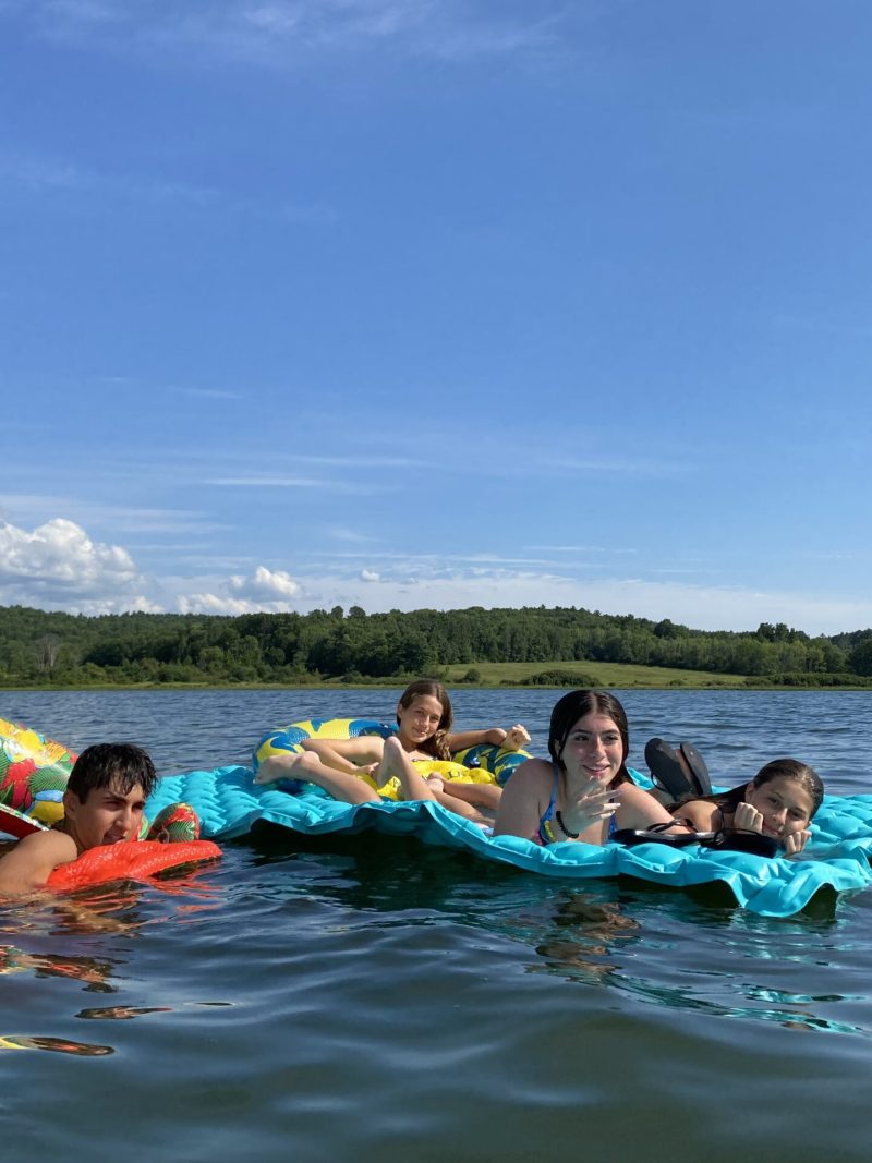 students on rafts in lake