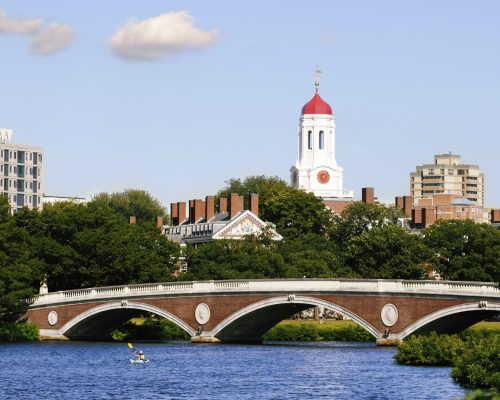View of Harvard University and pedestrian bridge on Charles River in Cambridge, Massachusetts